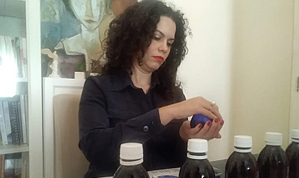 Irini Kokolaki getting ready to taste olive oil from a blue glass