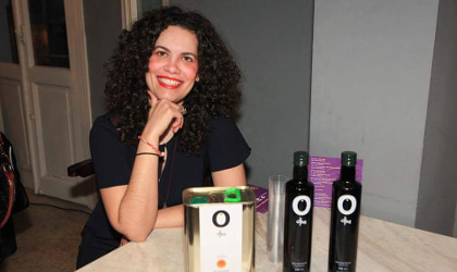 Irini Kokolaki with O Olive olive oil bottles and tin