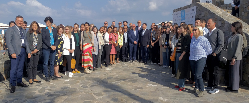 an outdoor photo of conference participants posing for a picture