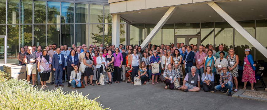 an outdoor photo of conference participants posing for a picture