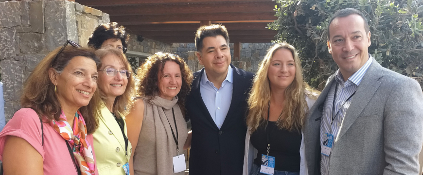 Ambassador Tsunis posing for a photo with several conference participants