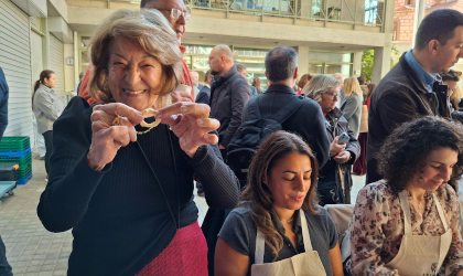 Dr. Antonia Trichopoulou holding up pasta she made at a pasta making workshop