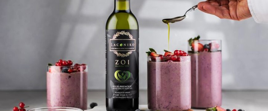 A bottle of ZOI extra virgin olive oil near glasses of pink smoothies