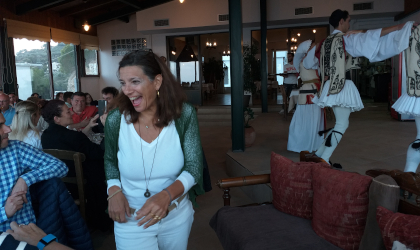 Cretan Lifestyle Conference participants reacting to costumed folk dancers at a taverna