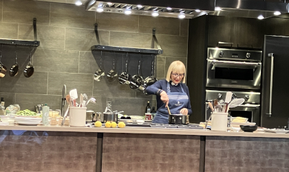 Chef Maria Loi stirring food in a kitchen