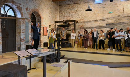 a group of visitors inside an olive oil museum